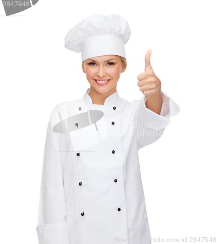 Image of smiling female chef showing thumbs up