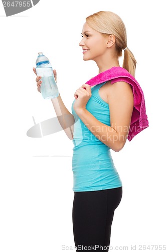 Image of sporty woman with towel and water bottle