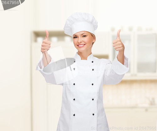 Image of smiling female chef showing thumbs up