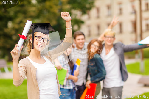 Image of smiling teenage girl in corner-cap with diploma