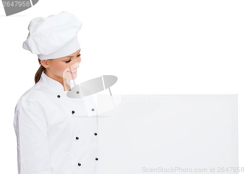 Image of smiling female chef with white blank board