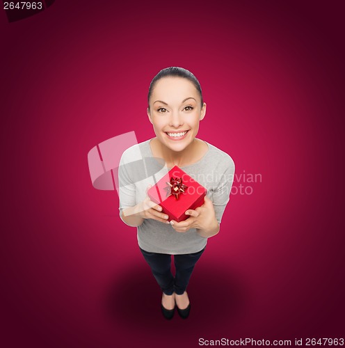 Image of smiling asian woman with red gift box