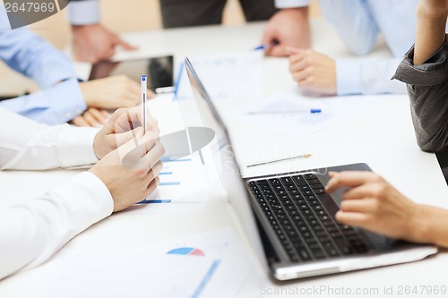 Image of close up of files and laptop computer in office