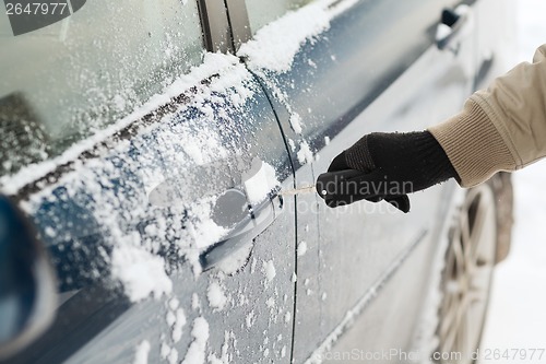 Image of closeup of man hand opening car with key