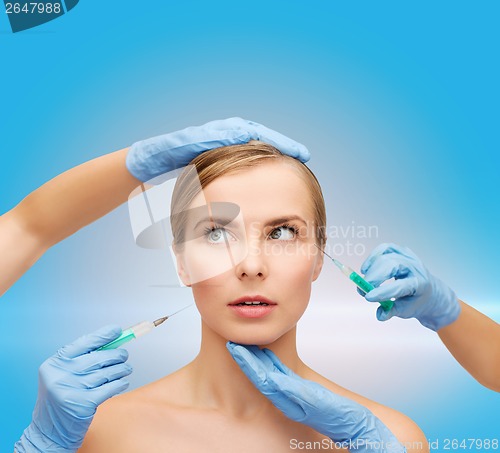 Image of woman face and beautician hands with syringe