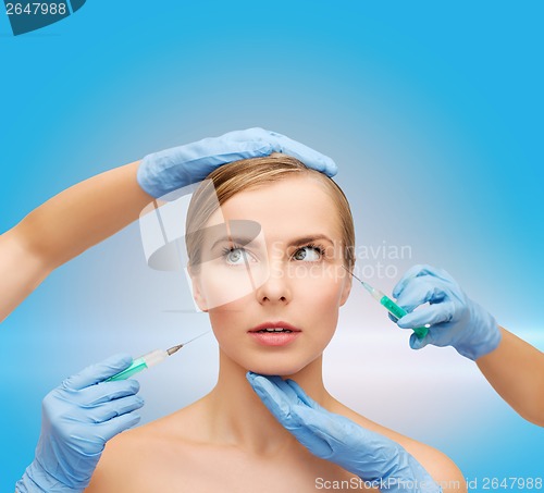 Image of woman face and beautician hands with syringe