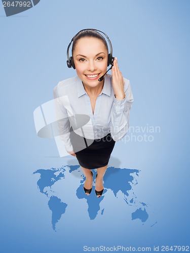 Image of friendly female helpline operator with headphones