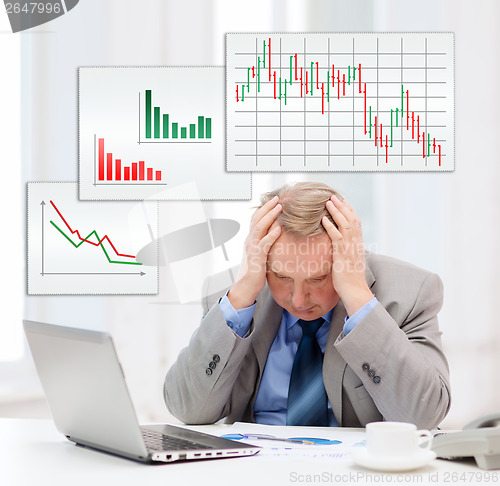 Image of upset older businessman with laptop in office