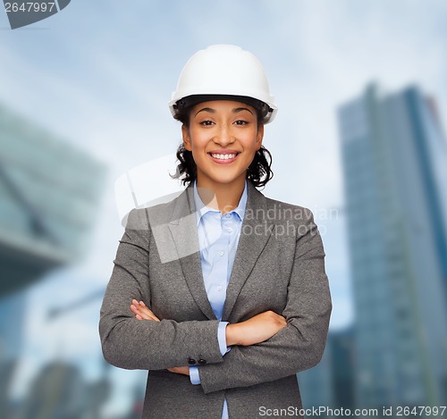 Image of businesswoman in white helmet with crossed arms