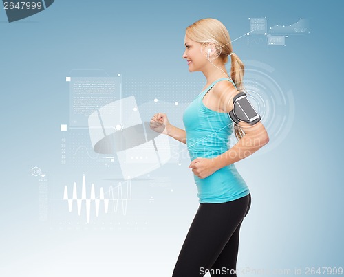 Image of sporty woman running with smartphone and earphones