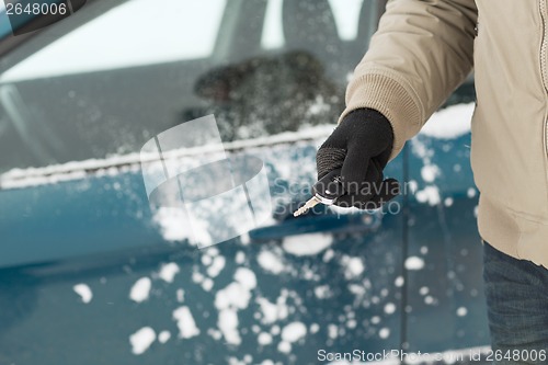 Image of closeup of man hand with car key outdoors