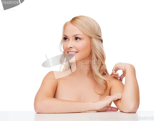 Image of woman touching her shoulder skin