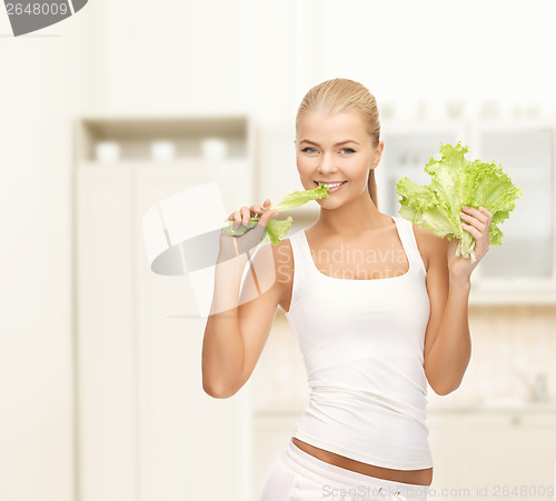 Image of woman biting lettuce