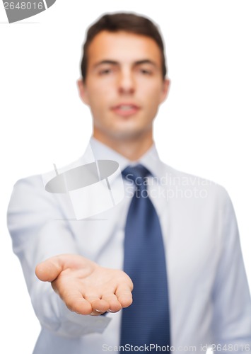 Image of friendly buisnessman showing something on the palm