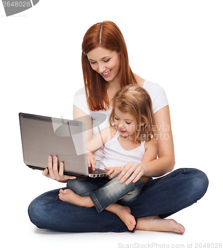Image of happy mother with adorable little girl and laptop