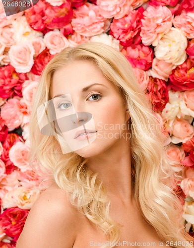 Image of beautiful woman and background full of roses