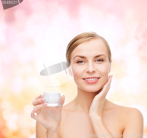 Image of woman applying cream on her skin