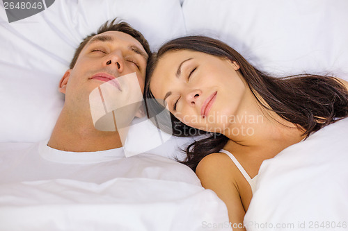 Image of happy couple sleeping in bed