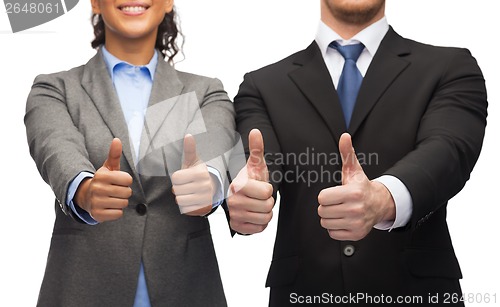 Image of businessman and businesswoman showing thumbs up