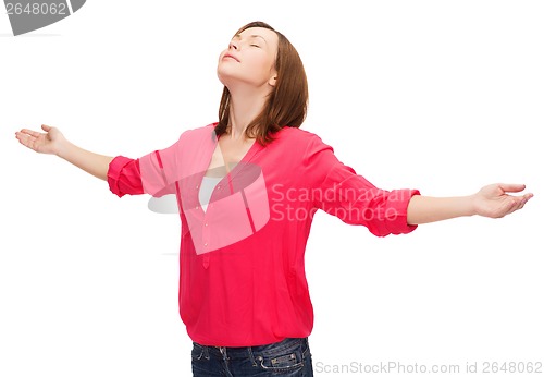 Image of smiling woman waving hands with closed eyes