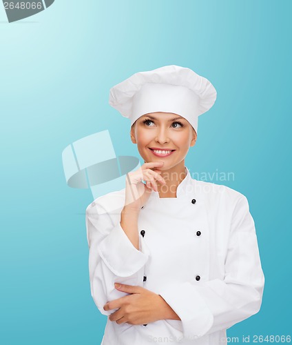 Image of smiling female chef dreaming