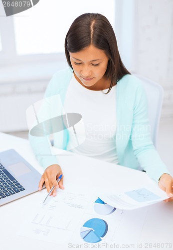 Image of businesswoman or student with laptop and documents