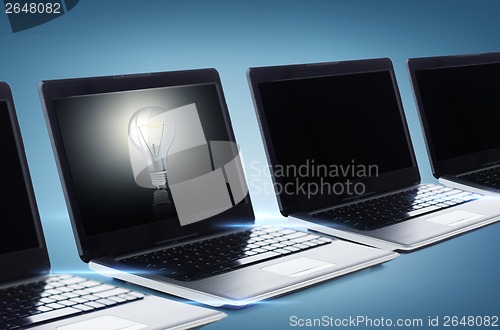 Image of many laptop computers with blank black screens