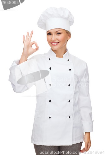 Image of smiling female chef showing ok hand sign