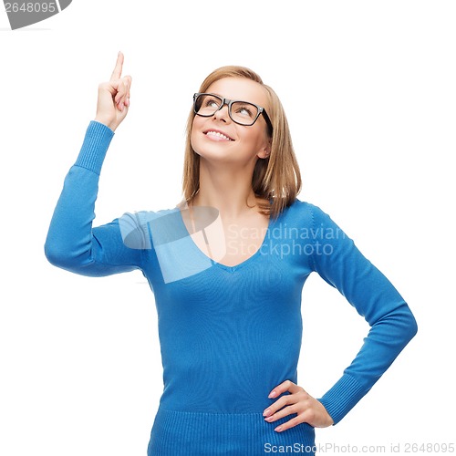 Image of smiling woman pointing her finger up