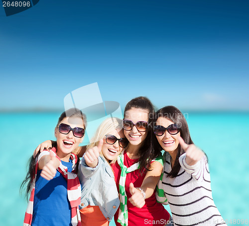Image of teenage girls or young women showing thumbs up