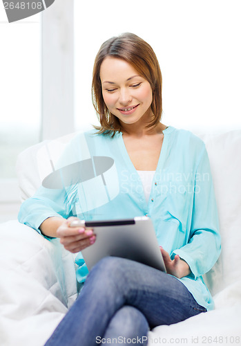 Image of smiling woman with tablet pc computer at home