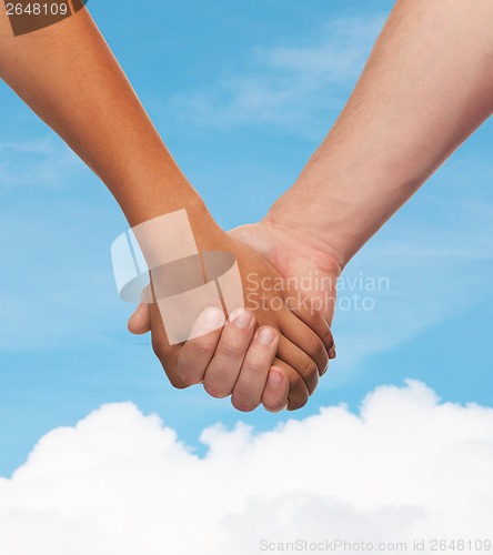 Image of woman and man holding hands