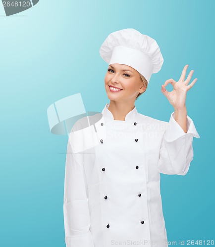 Image of smiling female chef showing ok hand sign