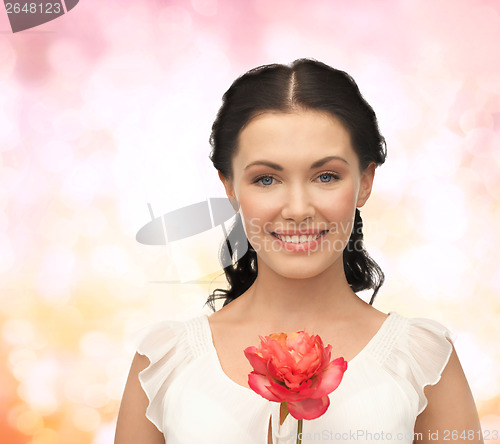 Image of young and beautiful woman with flower