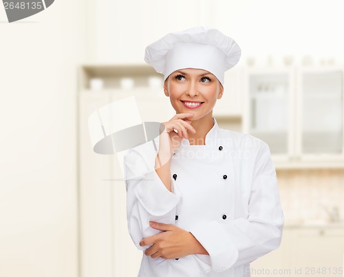 Image of smiling female chef dreaming
