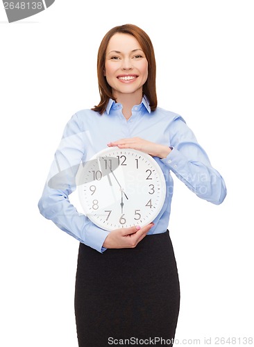 Image of attractive businesswoman with wall clock