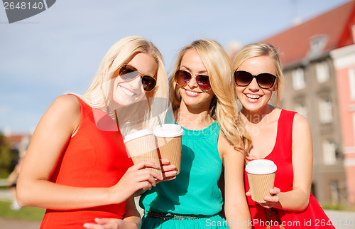 Image of women with takeaway coffee cups in the city