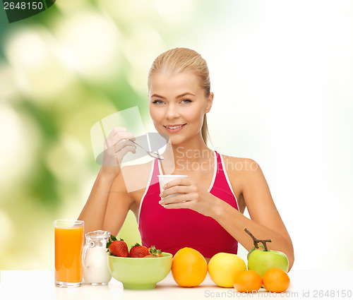 Image of young woman eating healthy breakfast