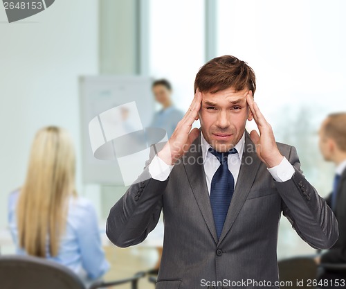 Image of stressed buisnessman or teacher having headache