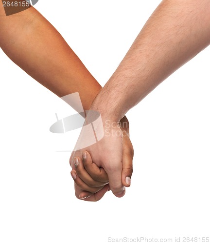 Image of woman and man holding hands