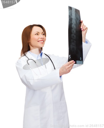 Image of smiling female doctor looking at x-ray