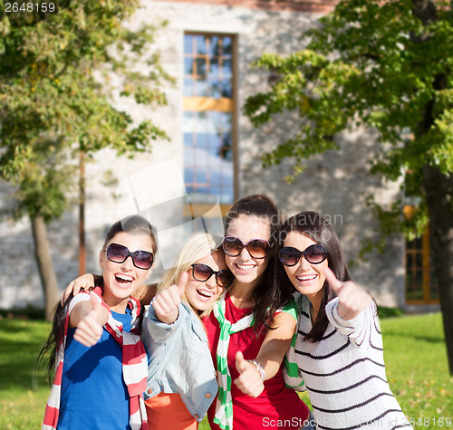 Image of teenage girls or young women showing thumbs up