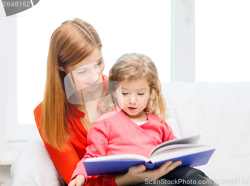 Image of happy mother and daughter with book