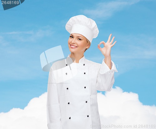 Image of smiling female chef showing ok hand sign