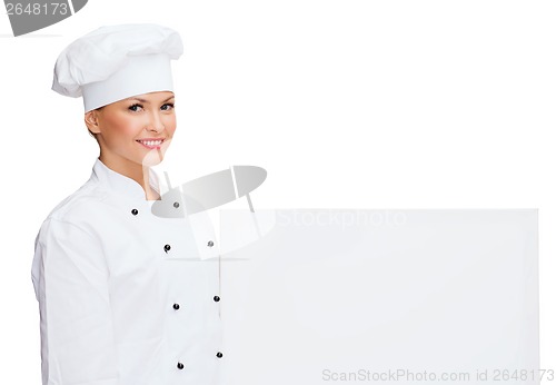 Image of smiling female chef with white blank board