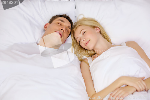 Image of happy couple sleeping in bed