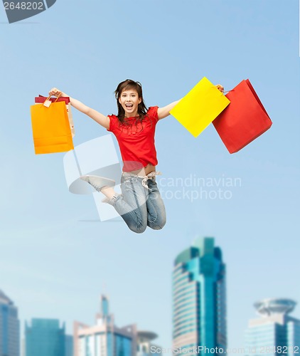 Image of excited girl with shopping bags