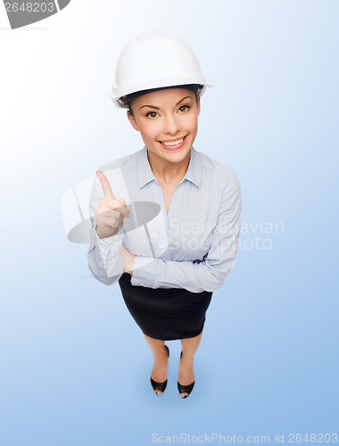 Image of businesswoman in white helmet with finger up