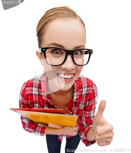 Image of student in glasses with folders showing thumbs up