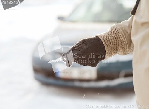 Image of closeup of man hand with car key outdoors